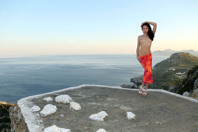 Spreading her legs on a cliff edge, Lila poses nude in bikini by the ocean with natural light — Lila #5