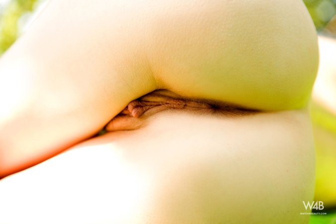 Lilian White stands bare in white lace outdoors, sunlight catching her curves as she poses slow — Lilian White #15